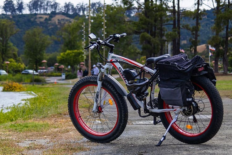 A white bike with gear on top of it.